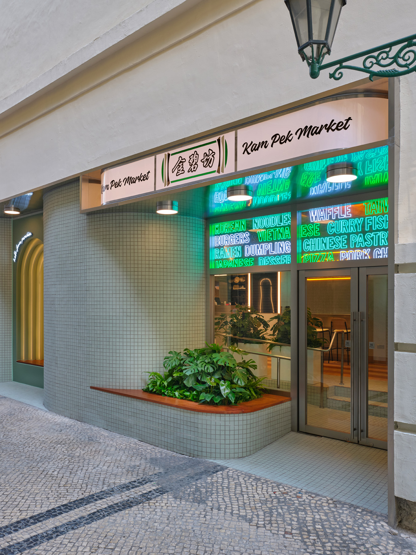 NIO Beijing interior lighting store with glowing curved façade and soft lighting design for retail store welcoming visitors at night.