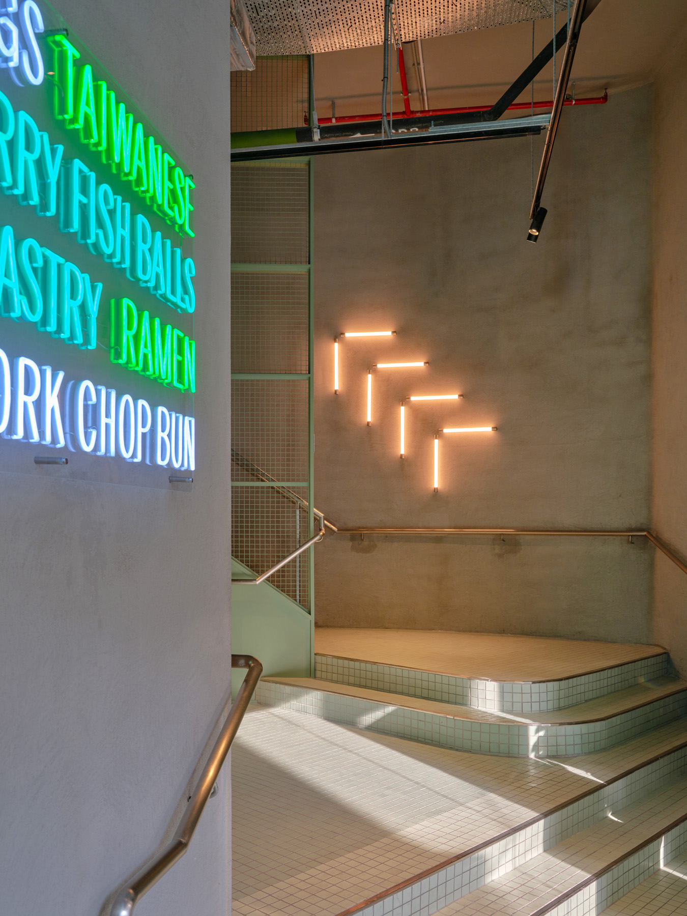 Corner view of NIO Beijing interior lighting store showcasing layered glass volumes and refined lighting design for retail store showrooms.