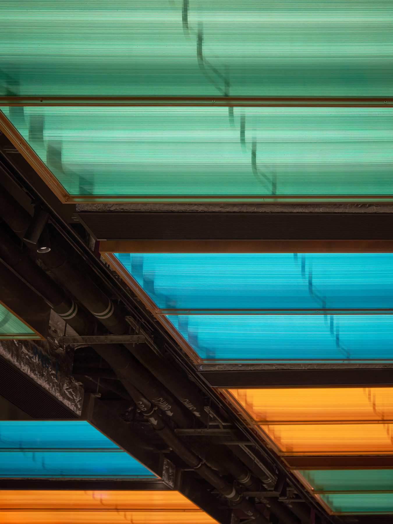 Minimal meeting corner in NIO Beijing interior lighting store with logo wall and calm lighting design for retail store consultation zone.