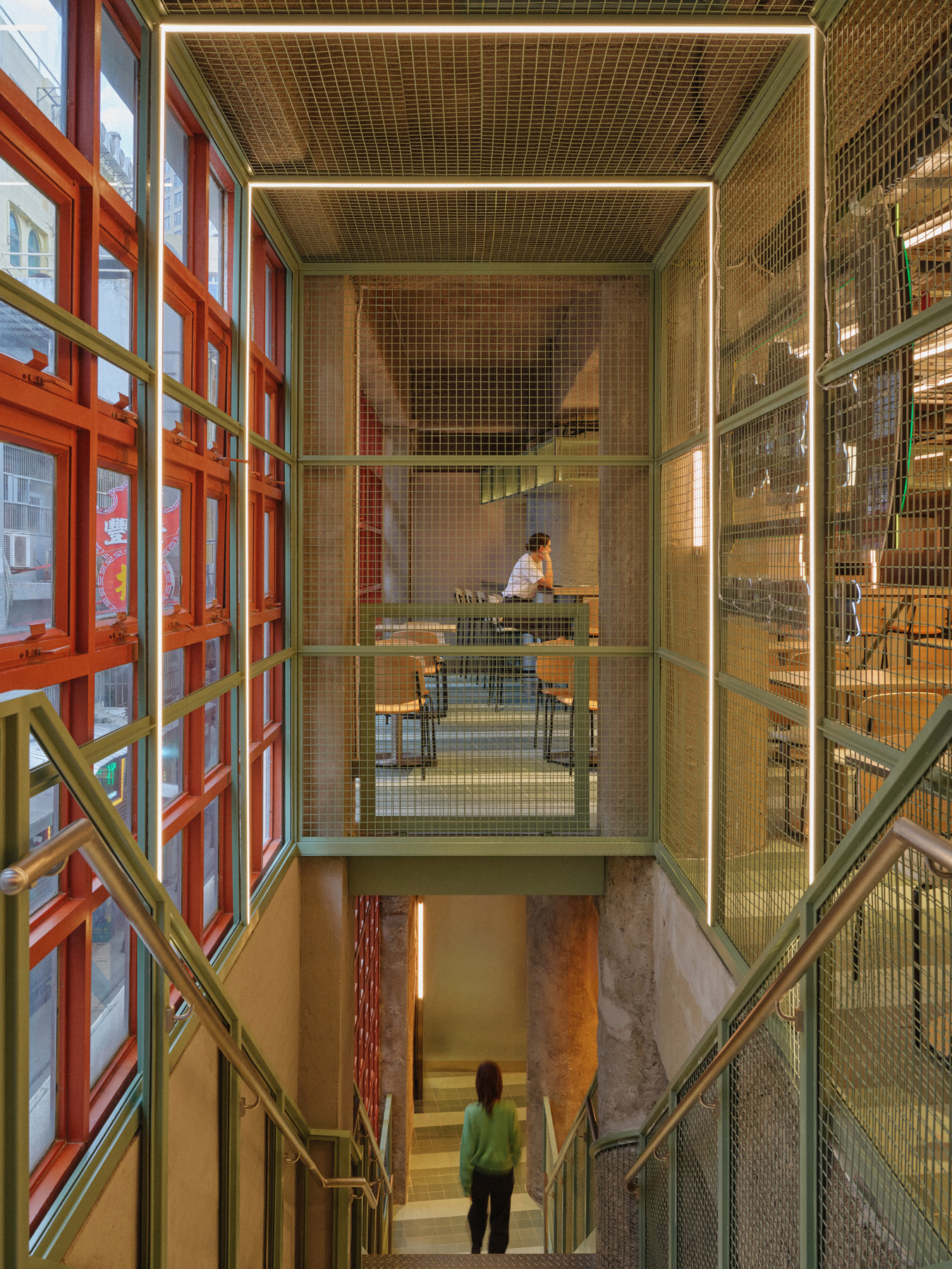 Minimal meeting corner in NIO Beijing interior lighting store with logo wall and calm lighting design for retail store consultation zone.